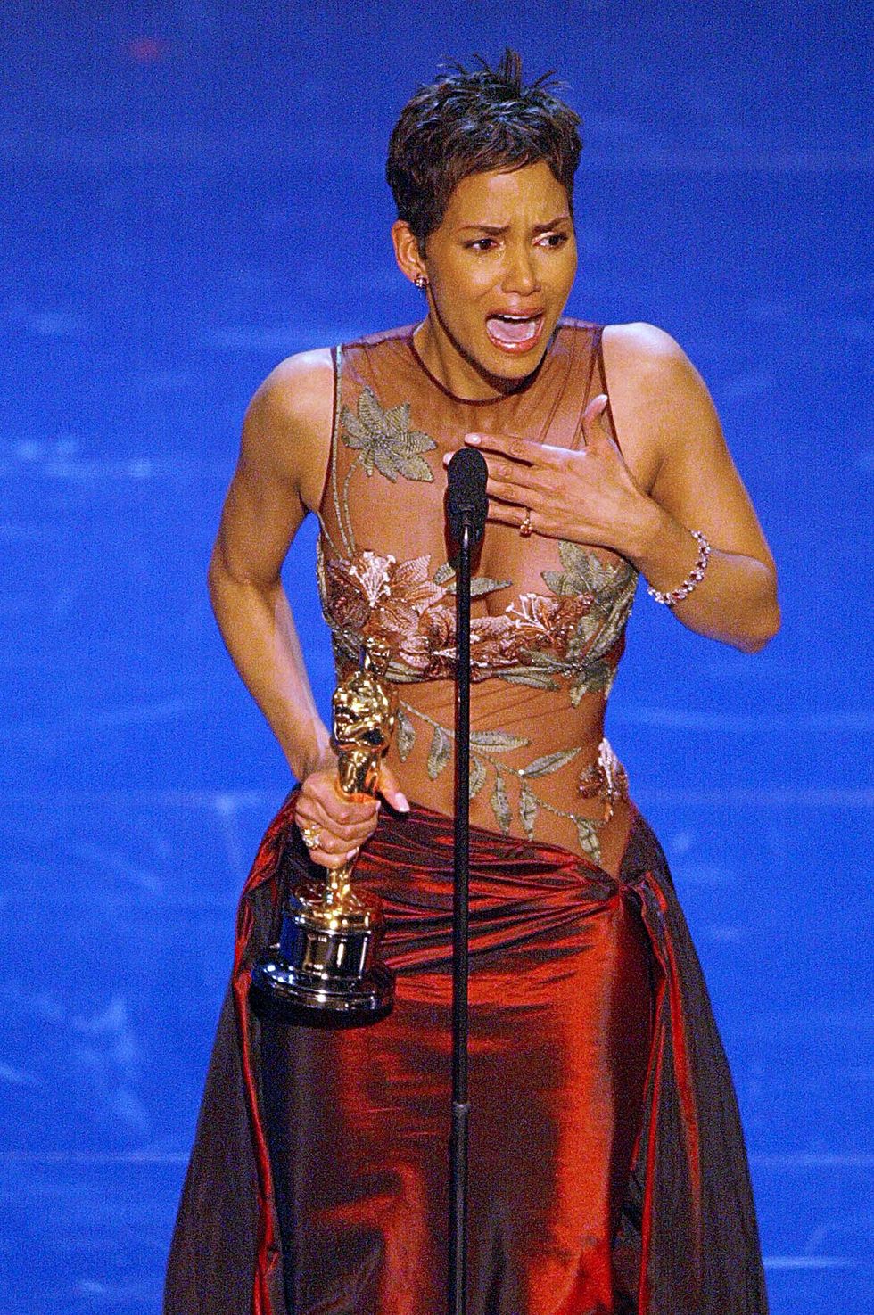 hollywood,   us actress halle berry accepts her oscar for best performance by an actress in a leading role during the 74th academy awards at the kodak theatre in hollywood 24 march 2002  afp photo  timothy a clary photo credit should read timothy a claryafp via getty images