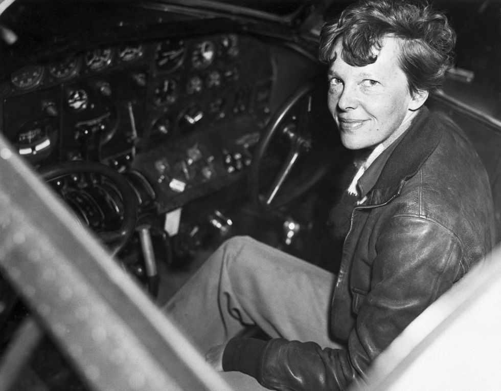 amelia earhart smiles as she sits clad in a leather aviators jacket in the cockpit of a small airplane one of the worlds most famous aviators, earhart was the first woman to fly solo across the atlantic ocean in 1932 while attempting to fly around the world in 1937 earhart and her co pilot and navigator frederick noonan crashed in the pacific ocean and neither their bodies nor their plane were ever found