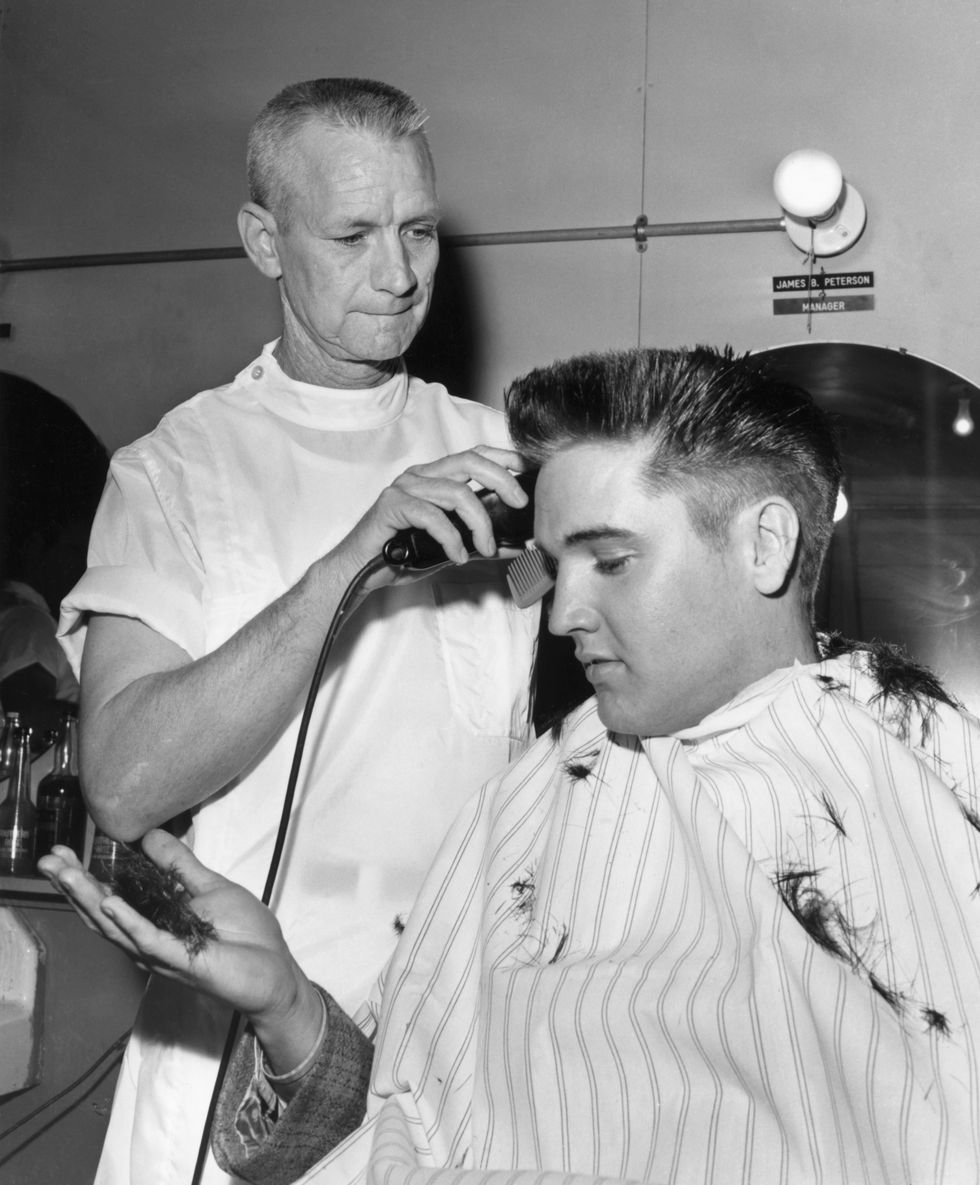 elvis presley receives a crew cut on his first full day as a member of the us army
