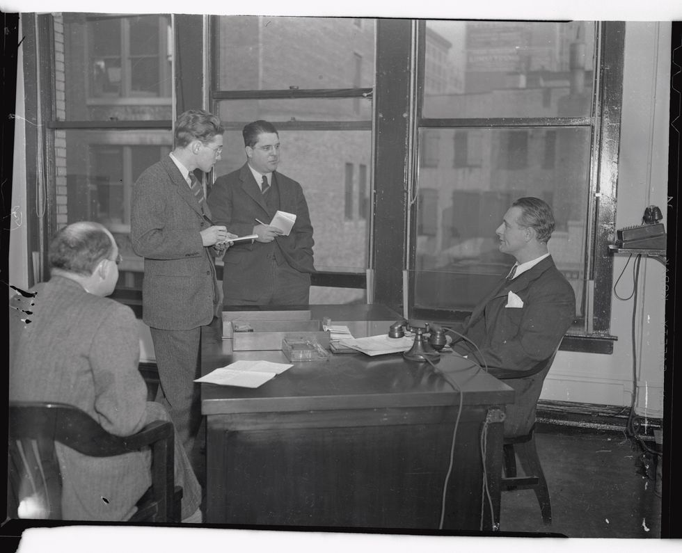 Lou Gehrig, former famous first baseman for the New York Yankees who was compelled to leave the diamond after having been struck with a form of paralysis, seen here as he began work as a member of the Parole Board of New York City in his office at 139 Centre Street today, January 2nd.