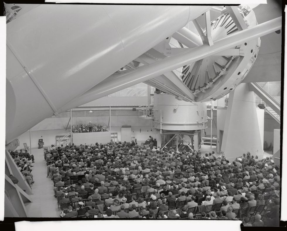 original caption over 800 invited guests attend the official dedication of the world's largest telescope at mt palomar as shown here the huge instrument, the heart of which is a 200 inch mirror weighing 500 tons, was named the hale telescope, after the late dr george ellery hale, who first envisioned the project 20 years ago