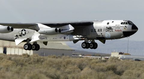 A B-52B launch aircraft lifts off with N