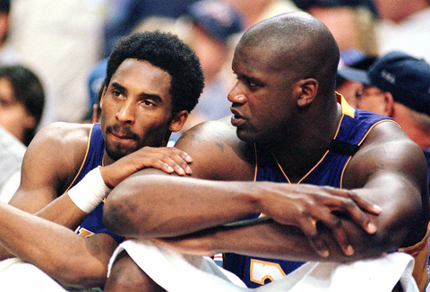 phoenix, az   may 14  los angeles lakers forward kobe bryant l speaks with teammate shaquille o'neal as they sit out the end of the fourth quarter against the phoenix suns in game four of the western conference semi finals 14 may 2000 at america west arena in phoenix the suns won 117 98  photo credit should read mike fialaafp via getty images