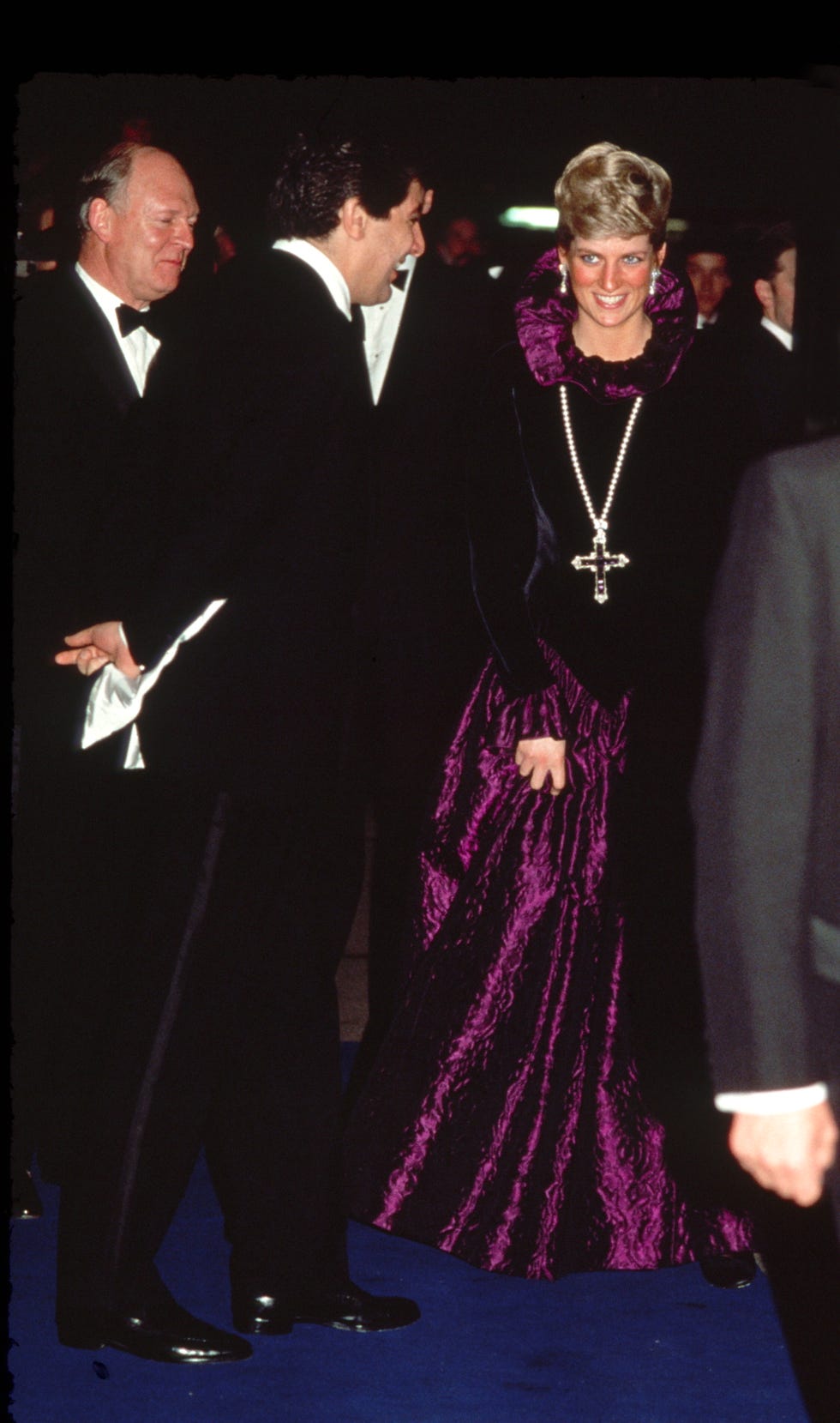 London, United Kingdom, October 27th Diana, Princess of Wales arrives at a charity gala on behalf of Birthright in Garrard. The princess wears a purple evening dress with a gold and amethyst crucifix hanging from a pearl rope. Photo by Tim Graham, Photo Library via Getty Images