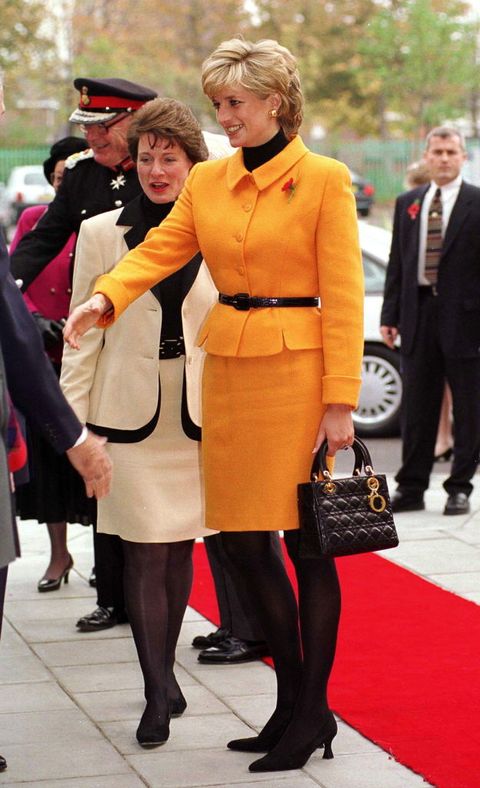 liverpool, united kingdom   november 07  princess diana visiting liverpool diana is wearing a bright orange suit designed by versace and she is carrying a dior handbag  photo by tim graham photo library via getty images