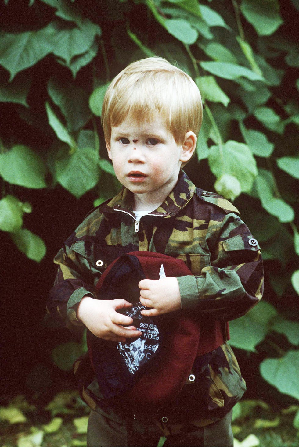 prince harry in a parachute uniform in the grounds of his home highgrove house with a cut on his nose caused by a fall