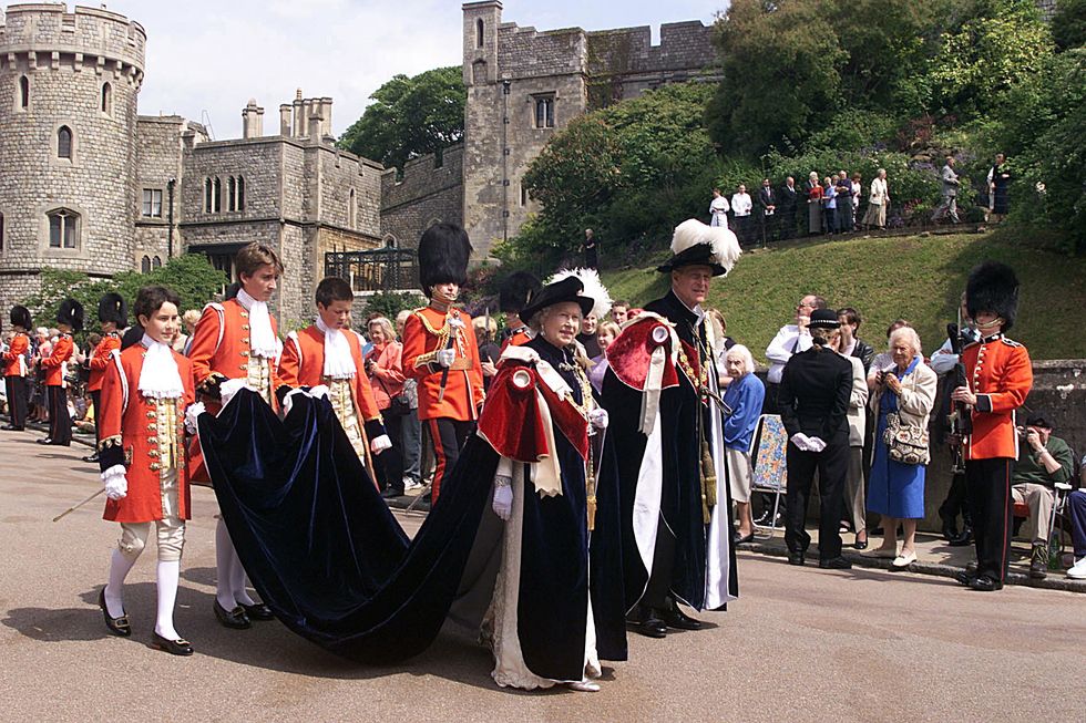 windsor, united kingdom june 16 pages of honour carrying the train of the queens mantle as she and prince philip duke of edinburgh walk to the chapel for the annual service for the order of the garter at st georges chapel, windsor castle, berkshire pages of honour are walter beckett and viscount chewton photo by tim graham picture librarygetty images