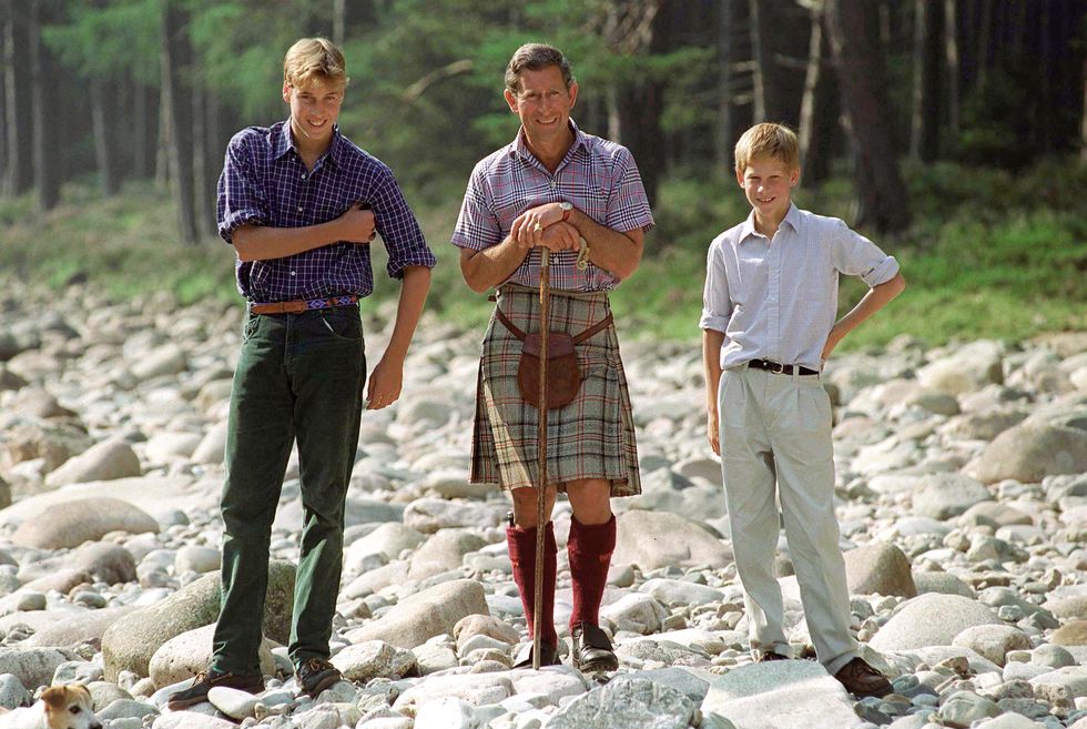 balmoral, united kingdom august 12 prince charles holding a walking stick styled as a shepherds crook stick with prince william and prince harry at polvier, by the river dee, balmoral castle estate photo by tim graham photo library via getty images