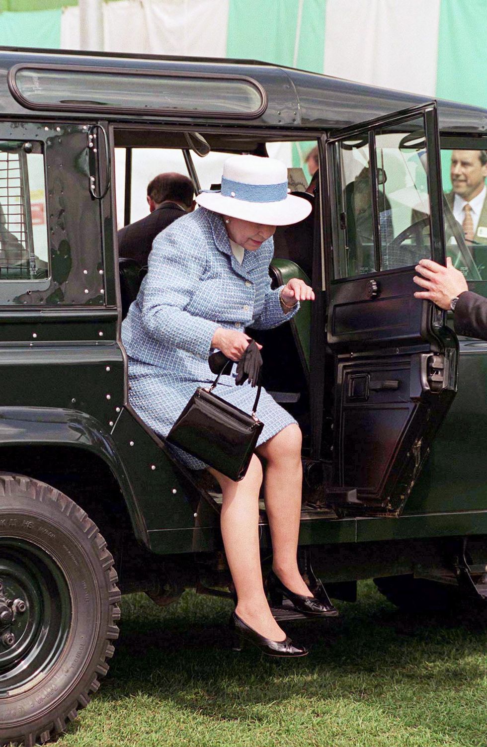 windsor, united kingdom   may 18  the queen facing an ungainly long leap from her land rover four wheel drive vehicle as she arrives for the royal windsor horse show at windsor castle  photo by tim graham photo library via getty images