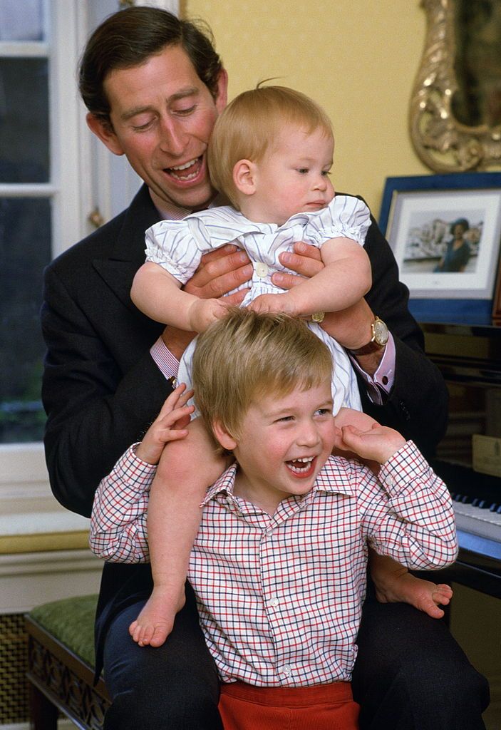 london, united kingdom   october 04  prince charles laughing with his sons as he lifts prince harry onto prince williams shoulders in kensington palace  photo by tim graham photo library via getty images