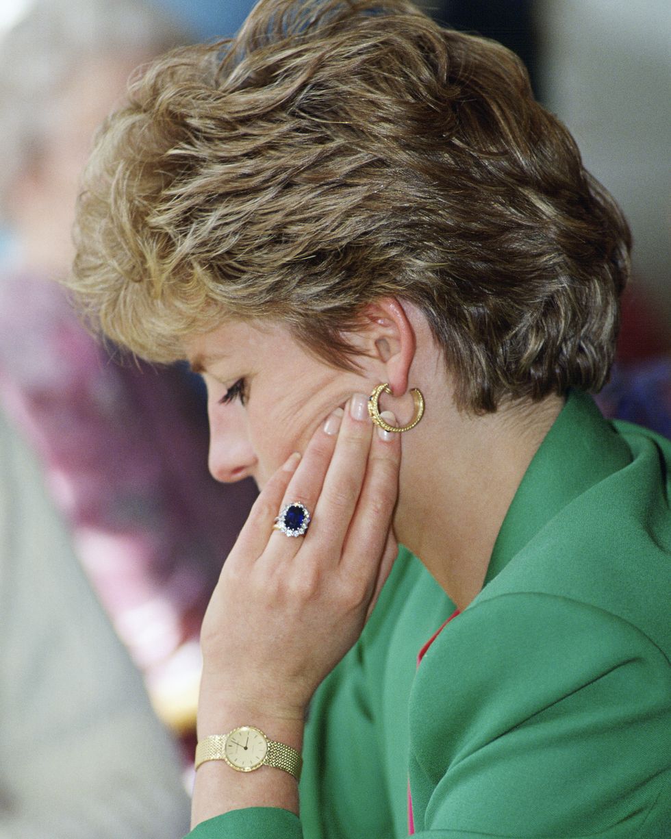 diana, princess of wales, wearing her diamond and sapphire engagement ring bought from garrards, the crown jewellers with a gold watch and gold earrings  photo by tim graham photo library via getty images