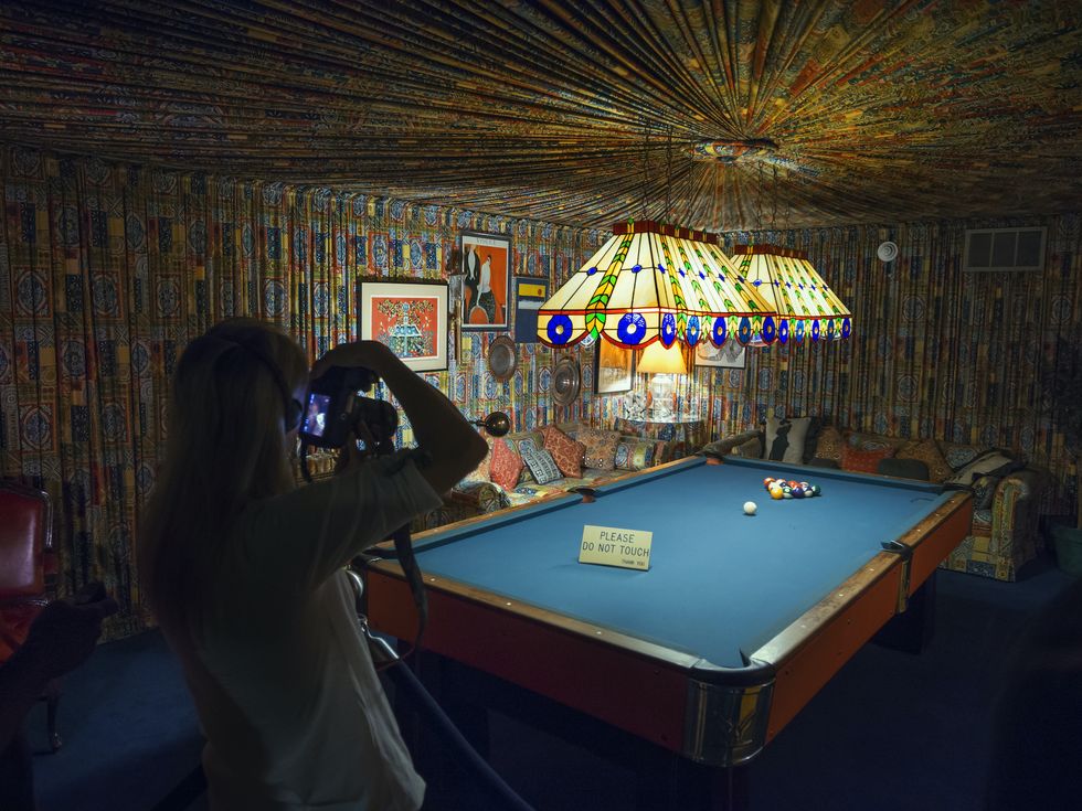 a woman photographs the pool room in graceland mansion, memphis, tennessee