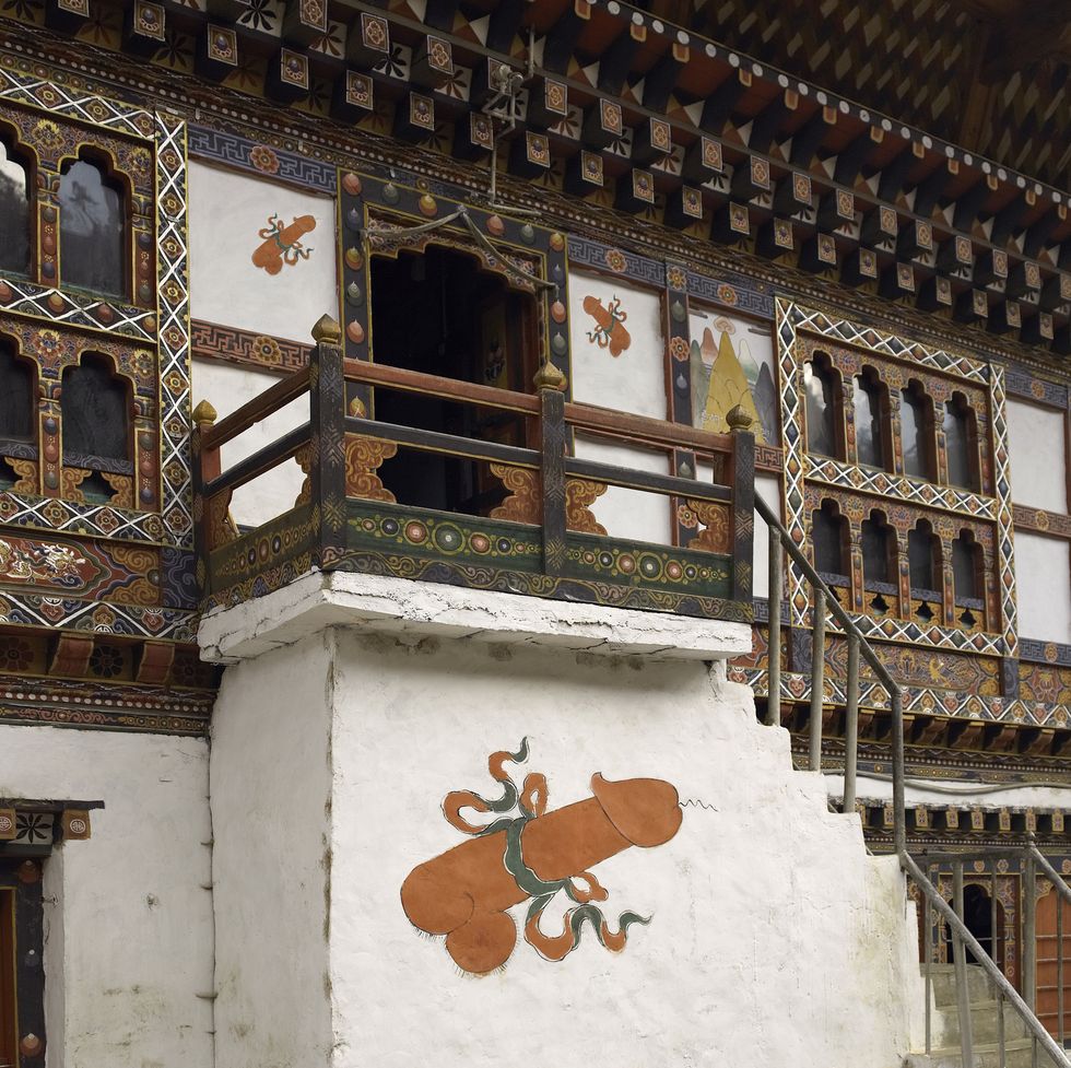 fertility symbols on a row of houses in the town of paro in the kingdom of bhutan