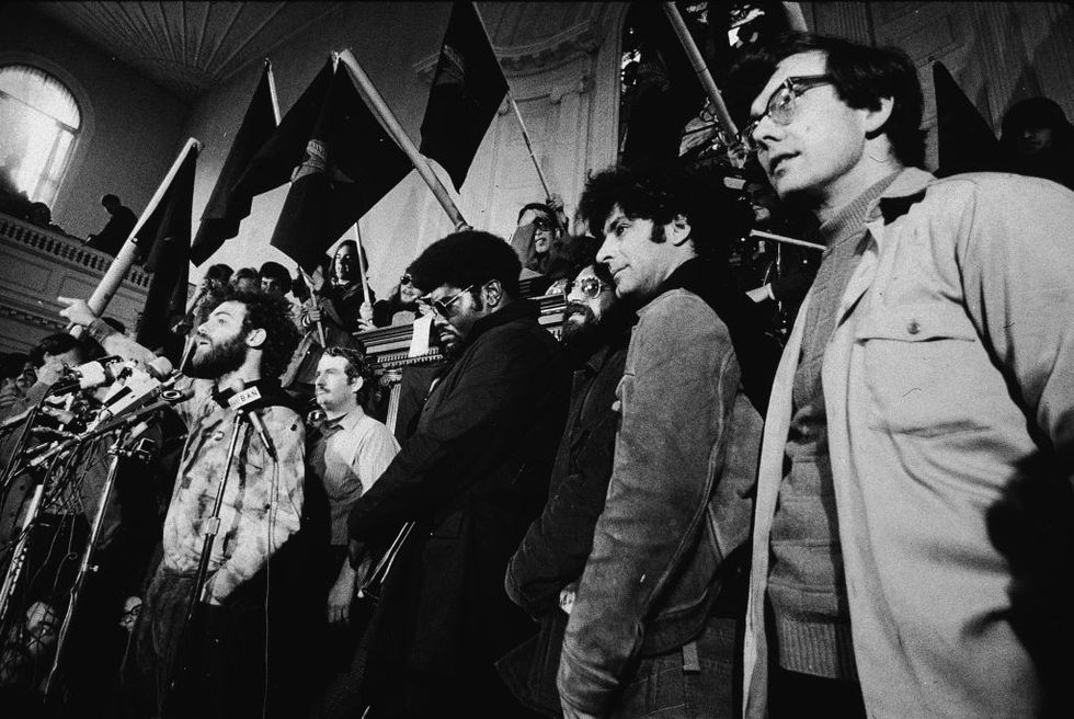 american activist jerry rubin 1938   1994 speaks at a news conference with other members of the chicago seven, including john froines, rennie davis, lee weiner and abbie hoffman 1936   1989, may 1, 1970 black panther elbert howard stands to his left the chicago seven were indicted for conspiracy and inciting to riot during the 1968 democratic national convention in chicago, illinois photo by silvermannew york times cogetty images