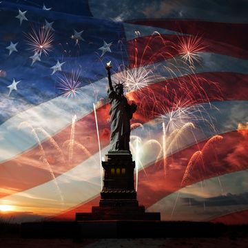statue of liberty on the background of flag usa, sunrise and fireworks