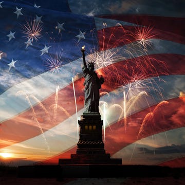 Independence day. Liberty enlightening the world statue of liberty on the background of flag usa, sunrise and fireworks