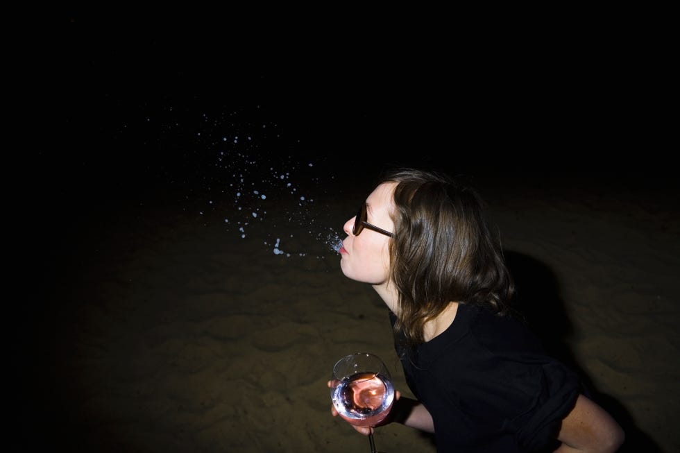woman spitting out wine