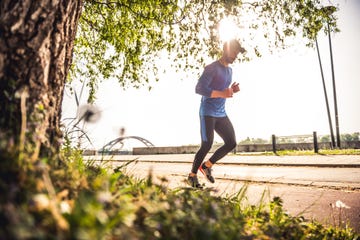 handsome male athlete jogging on a sunny day