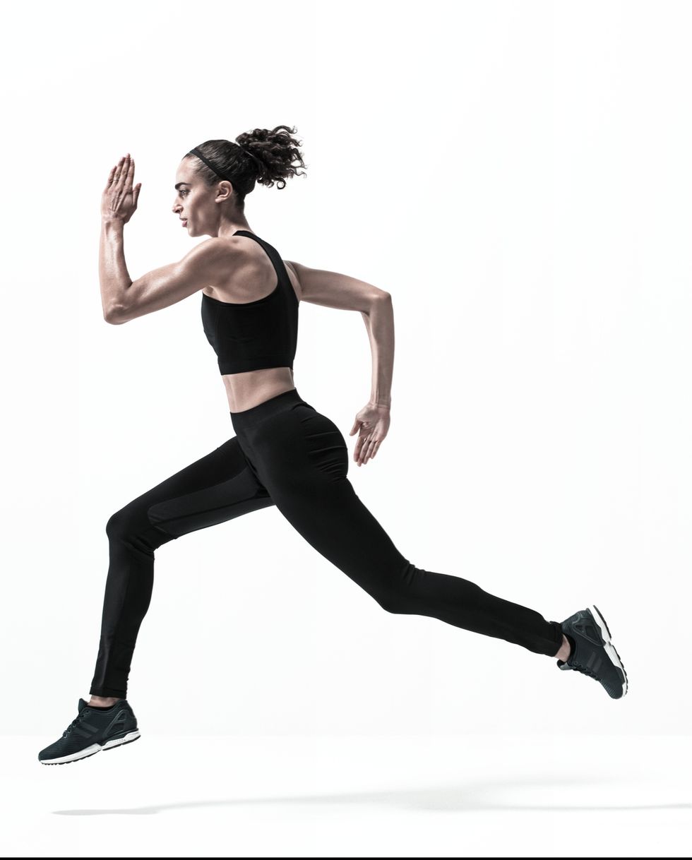 Young woman running fast on white background