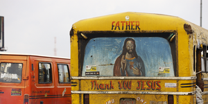 a painting of jesus and the message "thank you jesus" on the back of a bus in oshodi market in lagos