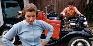 Adolescent Couple Separated by Roadster