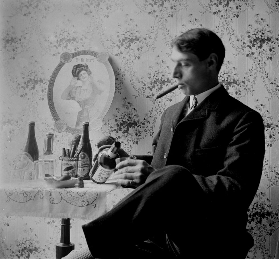 Victorian man pours himself a drink, ca. 1900