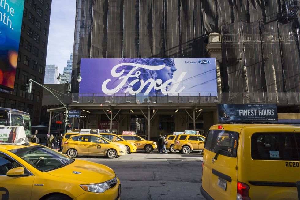 an advertisement for ford on the side of the under renovation hotel pennsylvania in new york on thursday, january 28, 2016 the ford motor co reported a healthy fourth quarter profit triggering a $9300 bonus for each of its uaw employees © richard b levine