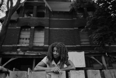 an african american cult member of move, founded by john africa, stands at the fence in front of their barricaded house in the powelton village section of philadelphia, pennsylvania photo by �� leif skoogforscorbiscorbis via getty images