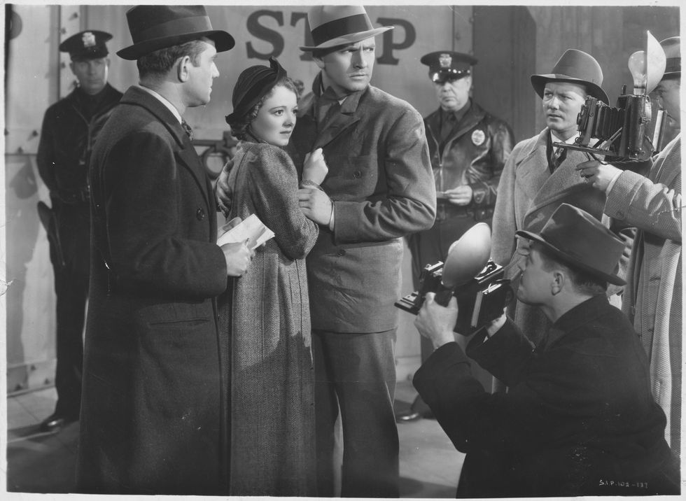 janet gaynor as vicki lester and fredric march as norman maine stand surrounded by photographers and reporters photo by �� john springer collectioncorbiscorbis via getty images