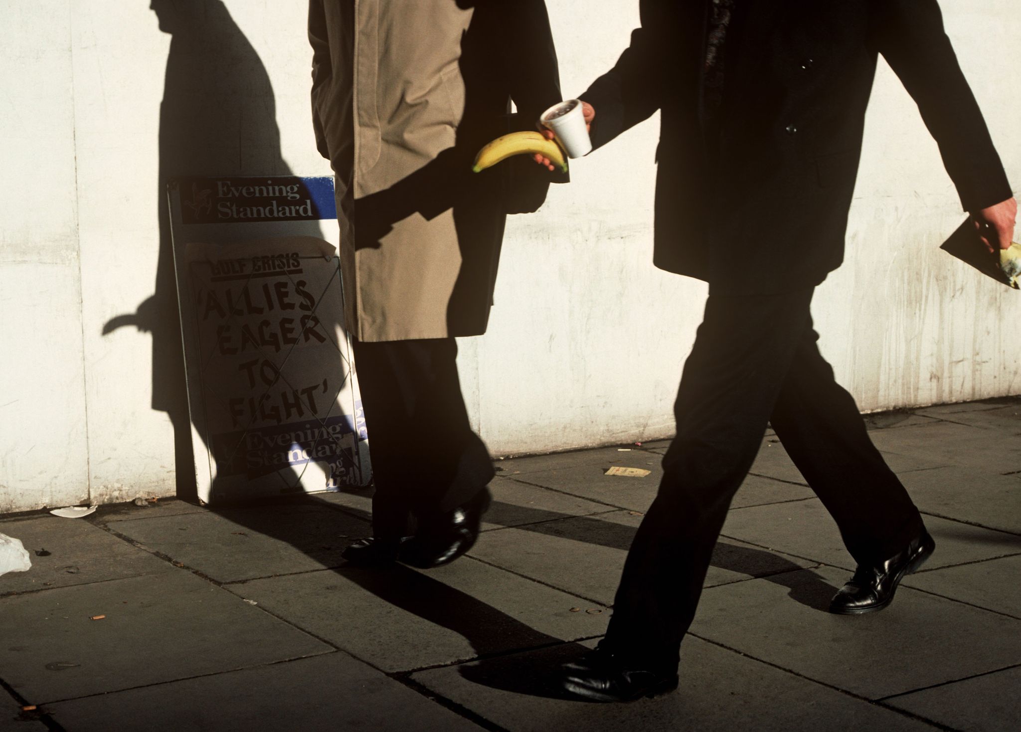 UK - London - Man striding with banana in hand
