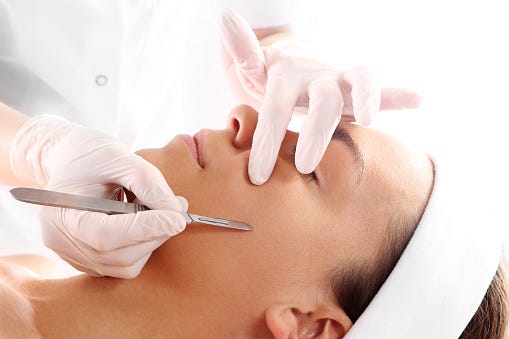 caucasian woman during surgery using a scalpel