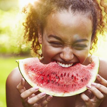 a boy eating a watermelon