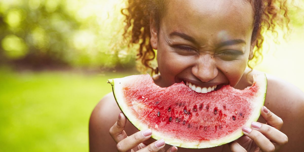 a boy eating a watermelon