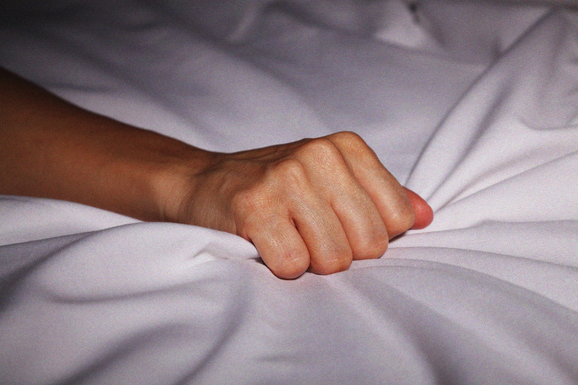 woman hand grabbing sheets