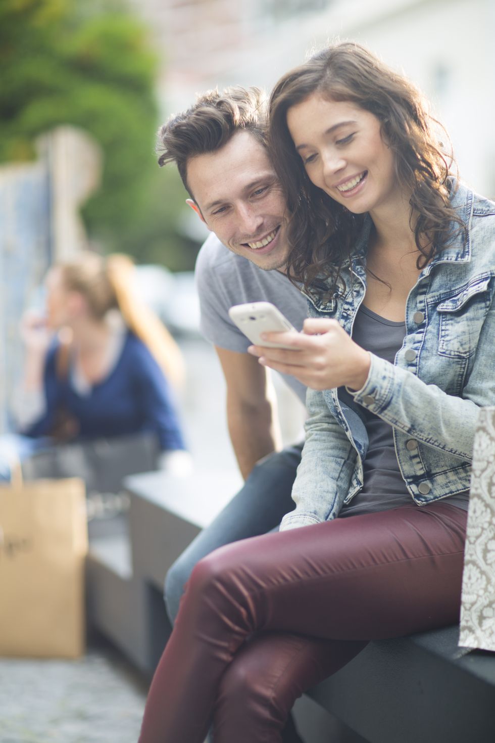 Portrait of young couple using smartphone