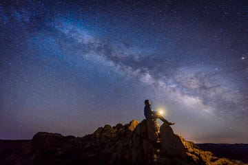 How to Stargaze: Man sitting under The Milky Way Galaxy