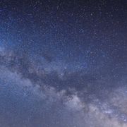 How to Stargaze: Man sitting under The Milky Way Galaxy