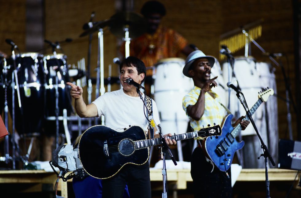 Paul Simon performs on stage during a tour to promote his "Graceland" album, February 1987