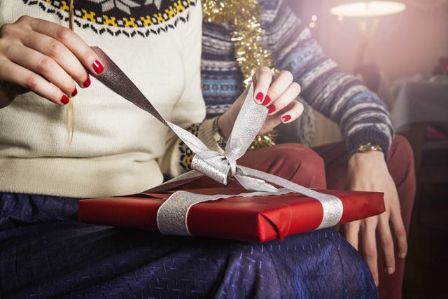 Woman unpacking present, close up.