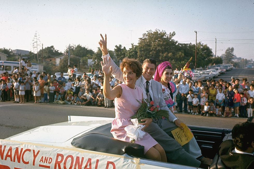 california, united states   1966  ca republican gubernatorial candidate ronald reagan,wife nancy l  unidentified female waving to spectators as they ride in back of convertible car outside while on the campaign trail  photo by bill raylife magazinethe life picture collection via getty images