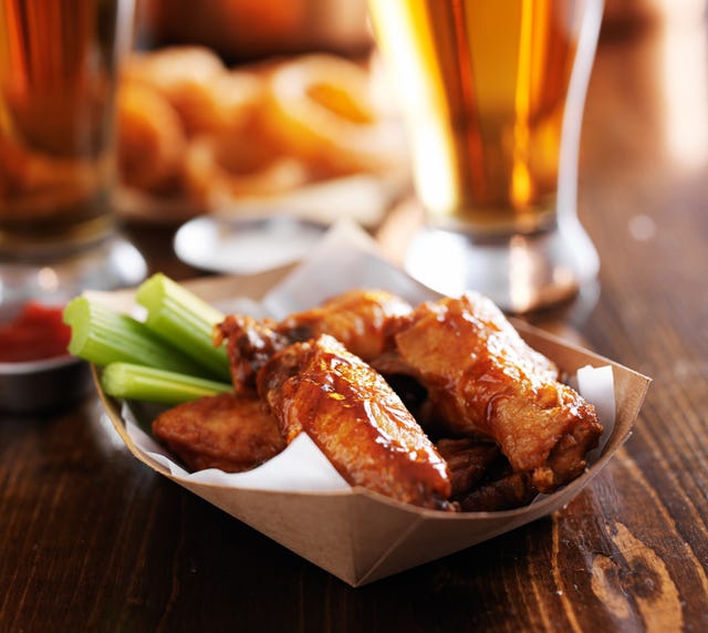 buffalo chicken wings with celery sticks and ranch sauce