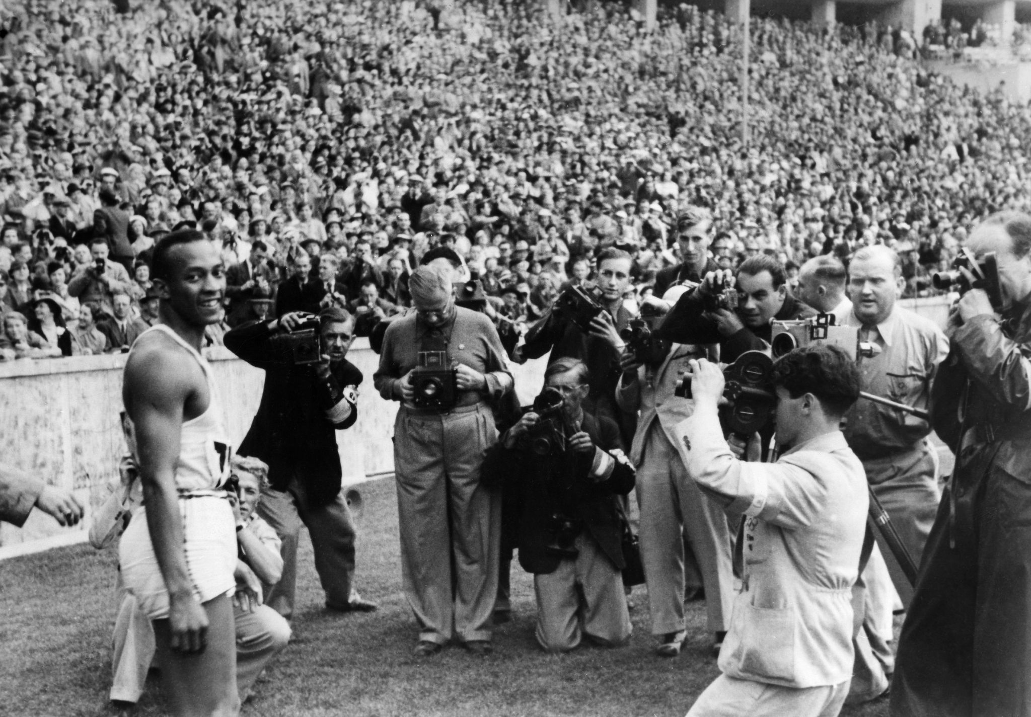 germany out jesse owens james cleveland owens,   12091913 31031980  , us american track and field athlete, won 4 gold medals at the summer olympics in berlin in 1936, summer olympics in berlin in august 1936 owens is surrounded by press photographers after winning the 100m sprint, among them is heinrich von der becke c, kneeling  photo by von der becke  ullstein bild via getty images