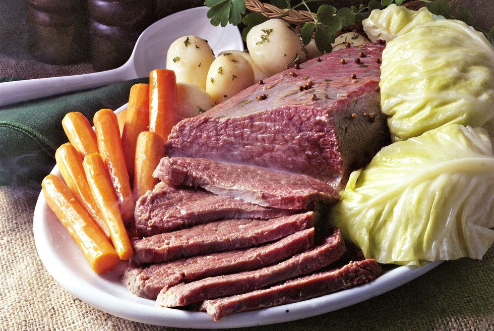 a platter of corned beef with cabbage,potatoes, and carrots