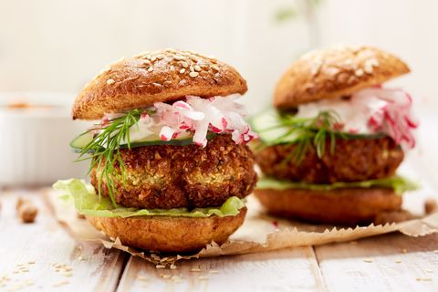 falafel burger with addition of fresh cucumber, radish and iceberg lettuce on a wooden rustic table healthy and delicious  vegetarian dish