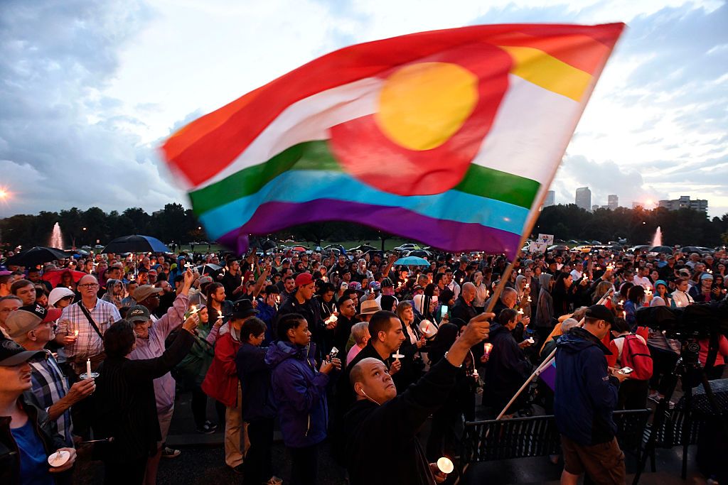 denver, co   june 13 mark wonder waves his rainbow color colorado flag as he and about 2,000 supporters attended the pflag denver chapter candle vigil june 13, 2016 at cheeseman park a silent candle vigil was held in support of the tragic event at pulse night club in orlando, florida  photo by john leybathe denver post via getty images