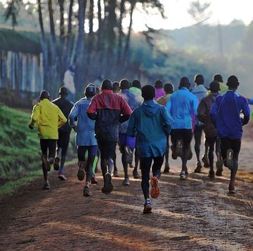 a young boy runs on his way to school alongside a group of elite runners, some of them members of kenyas national team for the rio2016 olympics, during a morning workout at kaptagat in eldoret town, aproximately 350 km north of the capital nairobi, on june 9, 2016 afp tony karumba photo credit should read tony karumbaafp via getty images