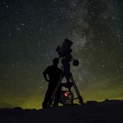 astronomer with telescope milky way