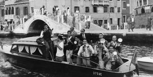 a motor launch filled with photographers following actress brigitte bardot and singer sacha distel down the canal during the venice film festival, italy, september 1958 bardot is there to attend the venice premiere of her latest film love is my profession, aka in case of adversity photo by archive photosgetty images
