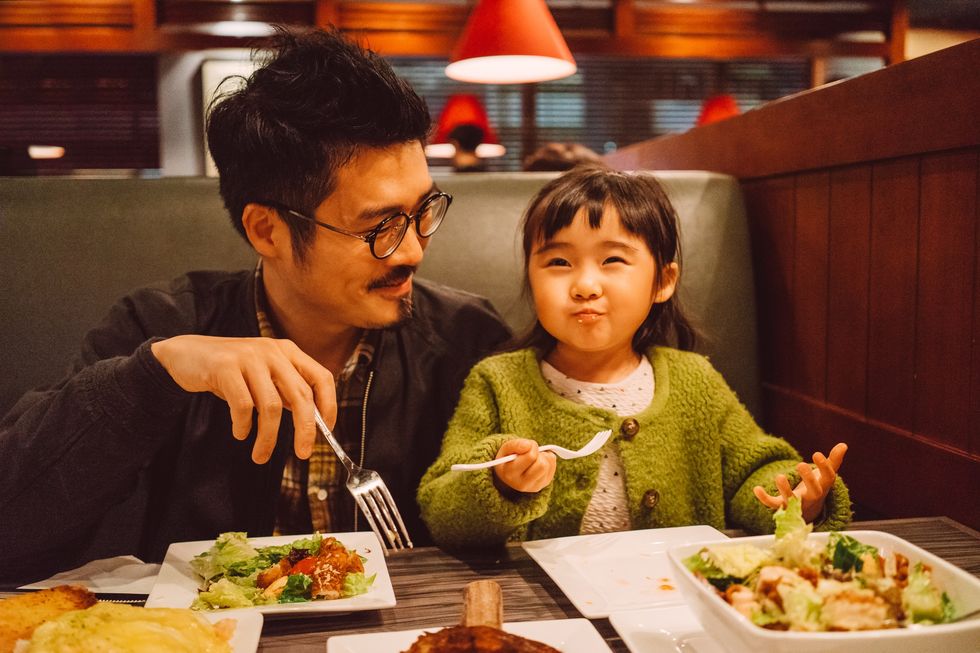 Dad & daughter enjoying meal in restaurant