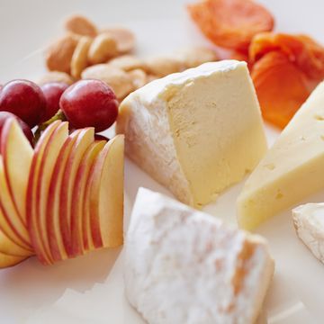 Close up of plate of fruit, cheese and nuts